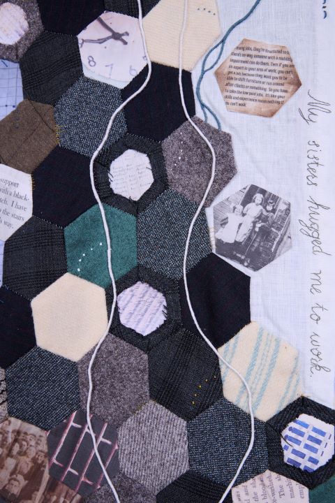 Photo by Jonathan Turner @jonturner on Instagram of extract of artwork. Hexagonal patches of cloth interspersed with printed photos of mill workers, text from archives and Factory Commissions evidence from disabled worker e.g., 'I support myself with a blackthorn crutch. The title, My sisters hugged me to work,' is embroidered down the right side.